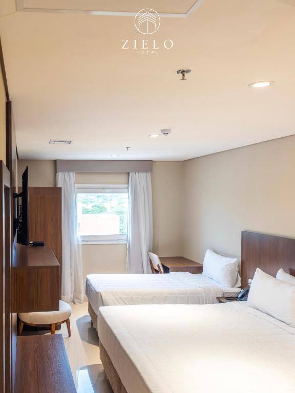 Postel nebo postele na pokoji v ubytování Zielo Hotel