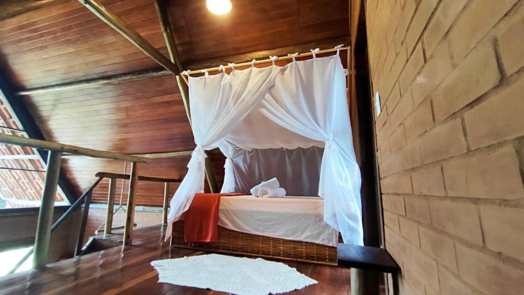 Giường trong phòng chung tại Chalé Nosso Cantinho - Vale do Capão BA