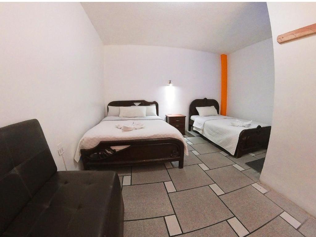 Postel nebo postele na pokoji v ubytování Hostal Anais