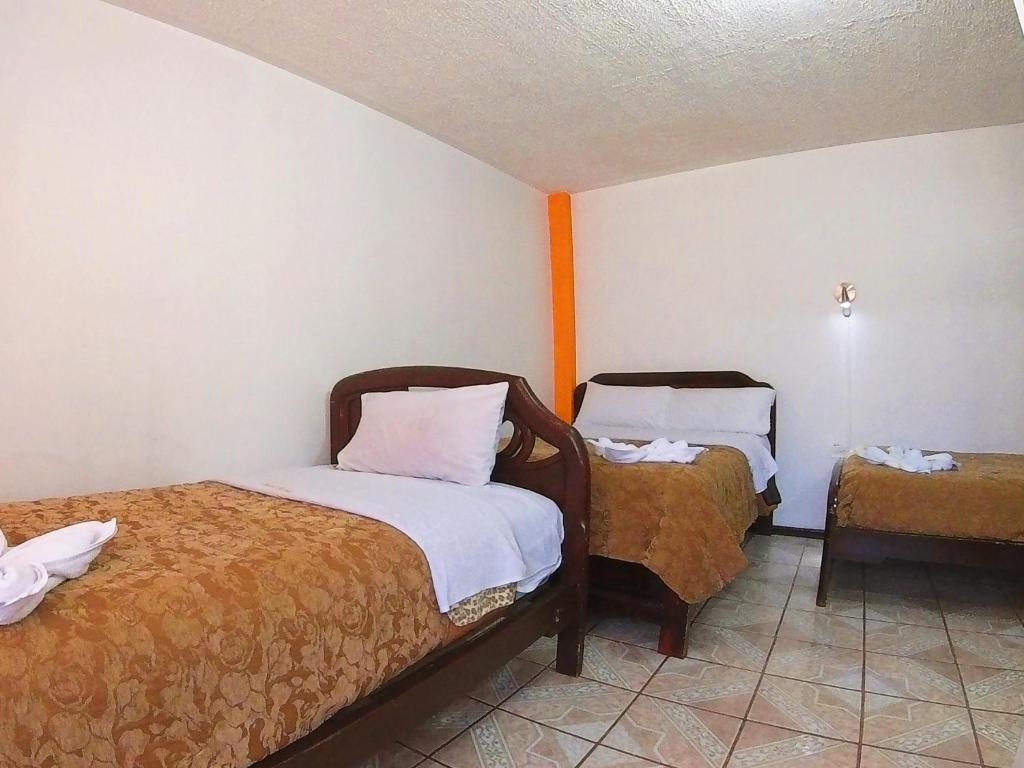Postel nebo postele na pokoji v ubytování Hostal Anais
