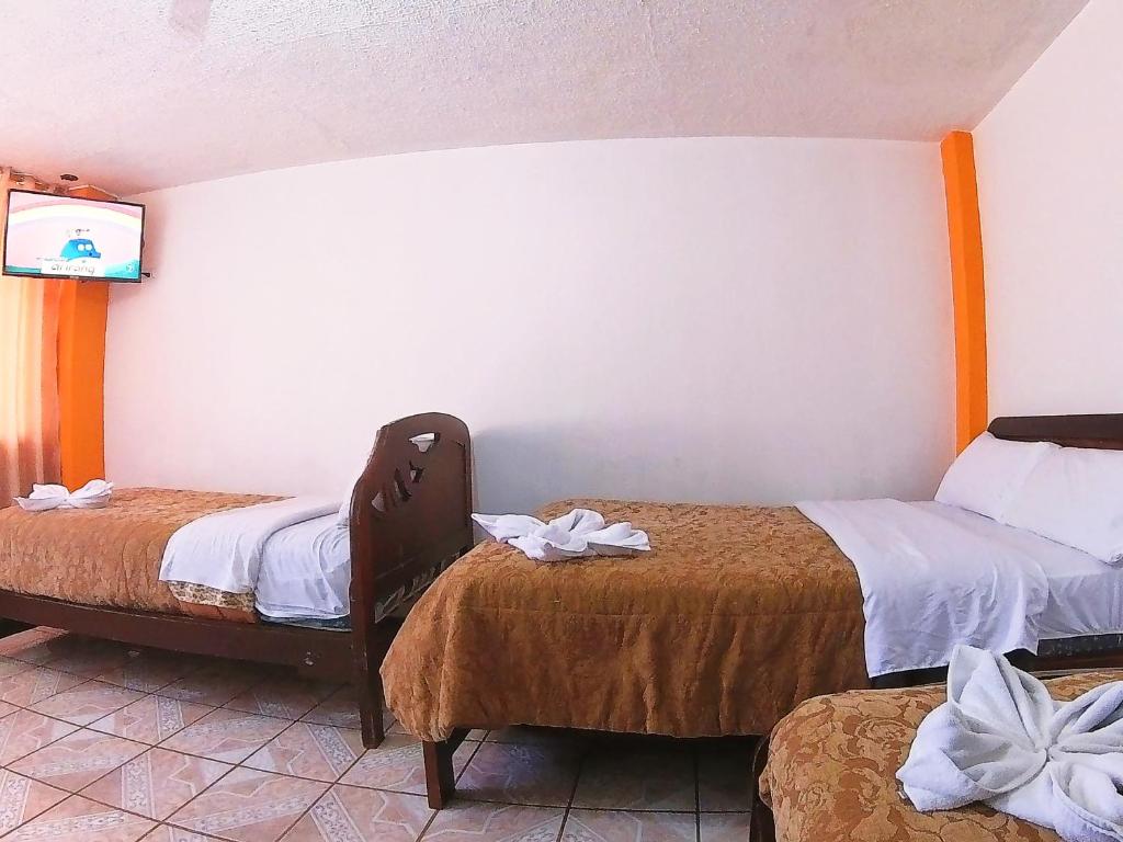 Postel nebo postele na pokoji v ubytování Hostal Anais