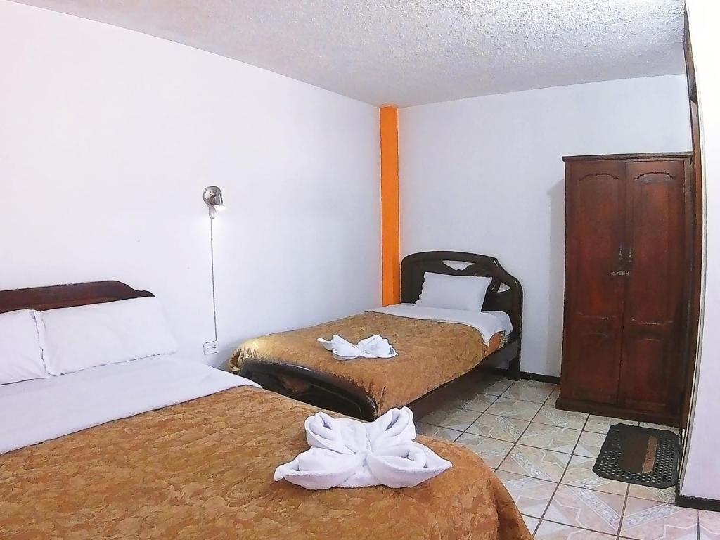 Postel nebo postele na pokoji v ubytování Hostal Anais