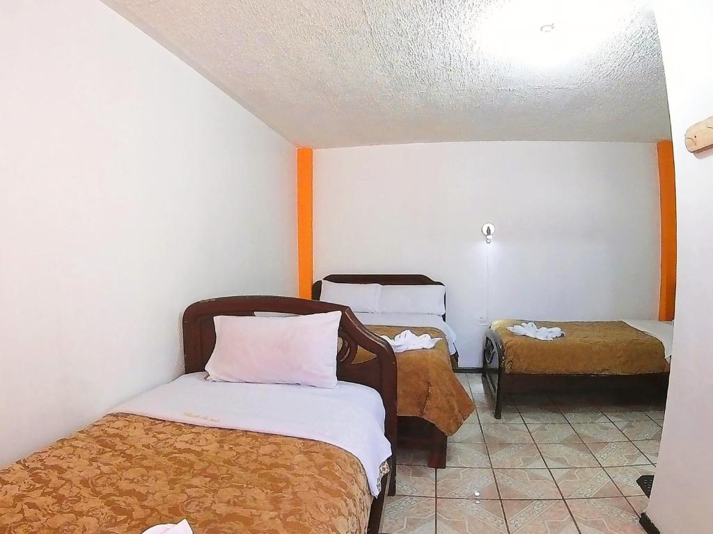 Postel nebo postele na pokoji v ubytování Hostal Anais
