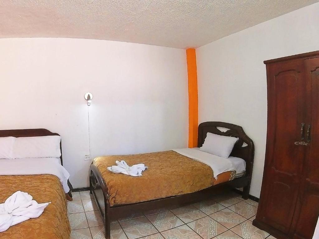 Postel nebo postele na pokoji v ubytování Hostal Anais