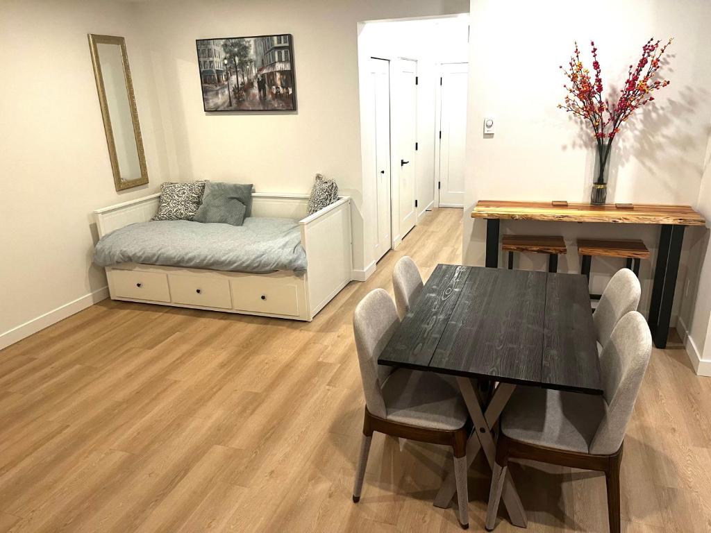 a dining room with a table and a couch at Brand new suite in langley close to everything in Langley