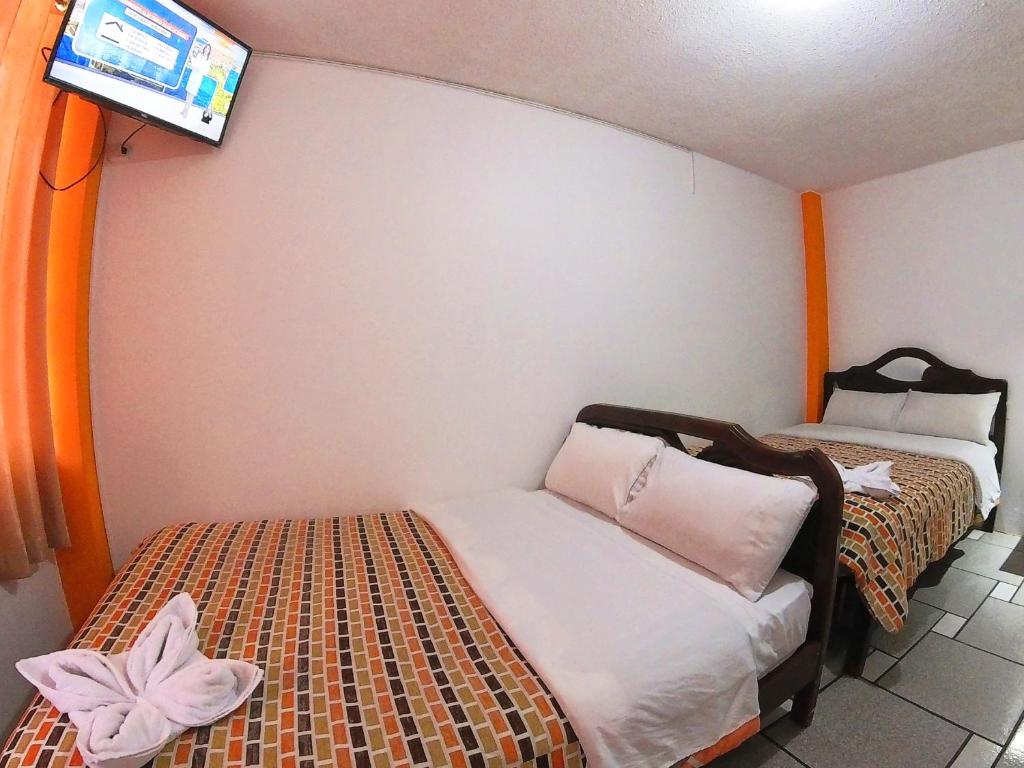 Postel nebo postele na pokoji v ubytování Hostal Anais