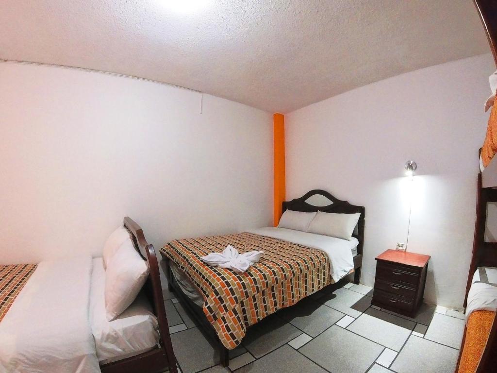 Postel nebo postele na pokoji v ubytování Hostal Anais
