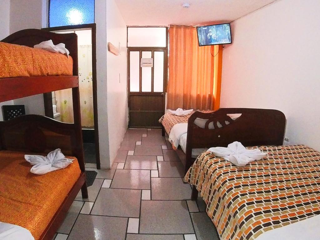 Postel nebo postele na pokoji v ubytování Hostal Anais