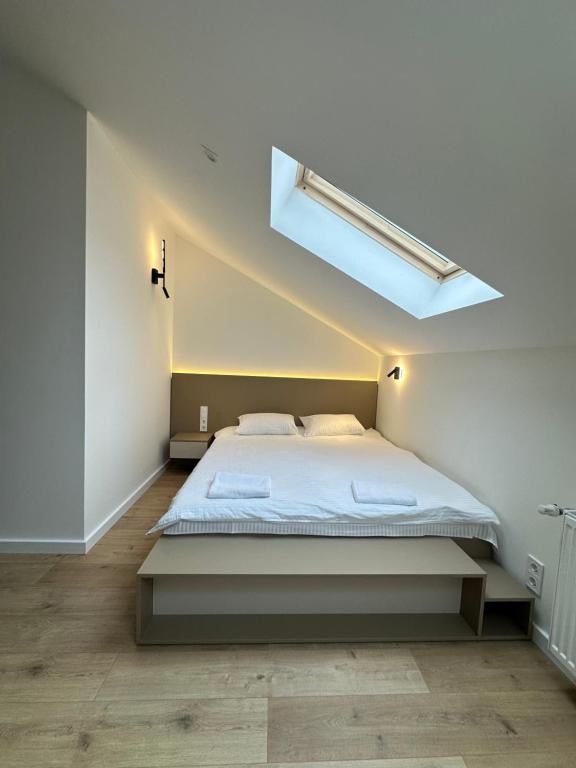 a bedroom with a large bed with a skylight at Apartment suite Mukachevo in Mukacheve
