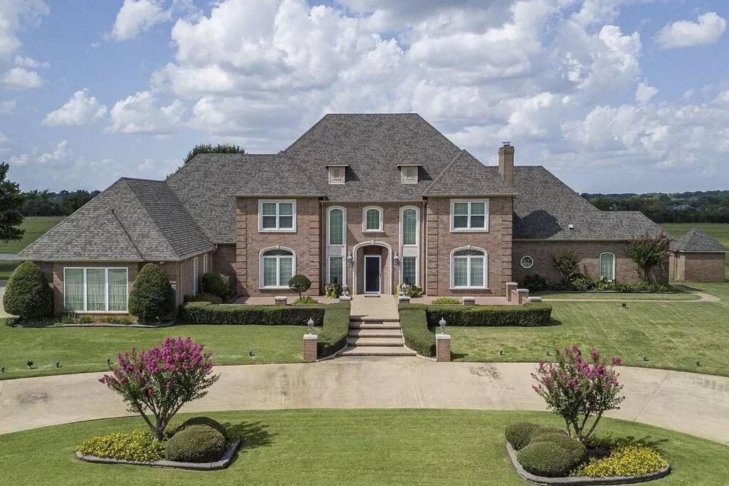 a large brick house with a landscaping at 5-Bedroom Home to Texoma lake and Casino in Durant