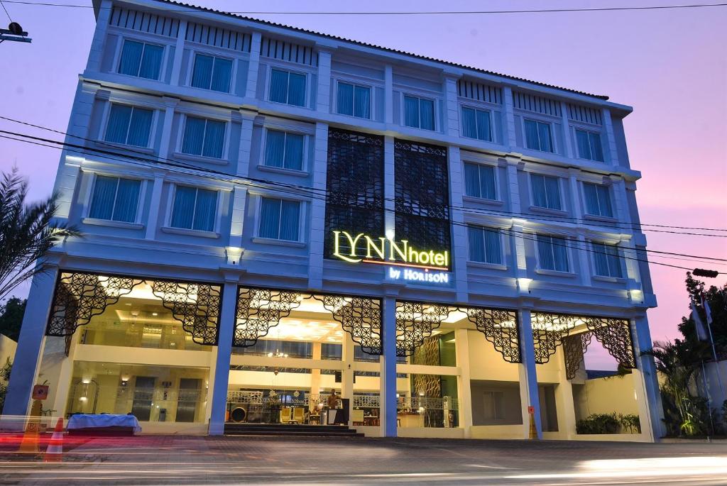 a building with a sign on the front of it at LYNN Hotel by Horison in Yogyakarta