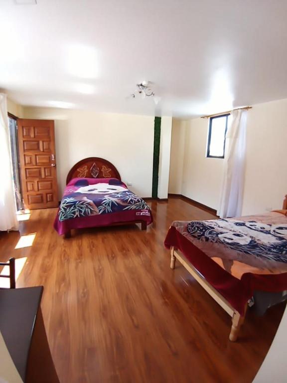 Postel nebo postele na pokoji v ubytování Hostal Atlantis
