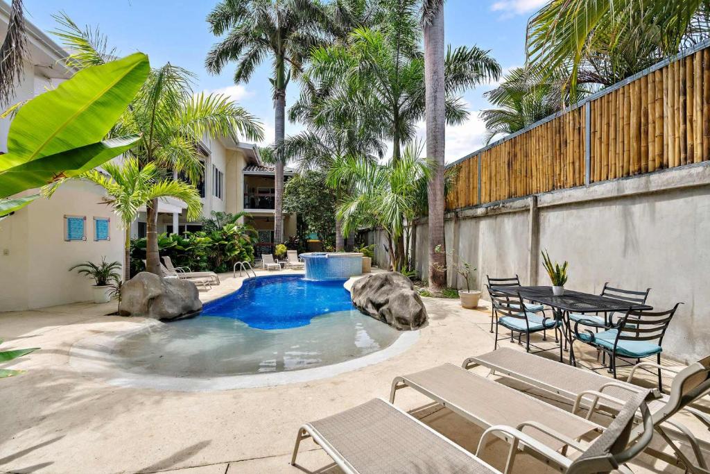 a patio with a pool with chairs and a table at 1-BD Near Beach Great for Digital Nomads in Potrero