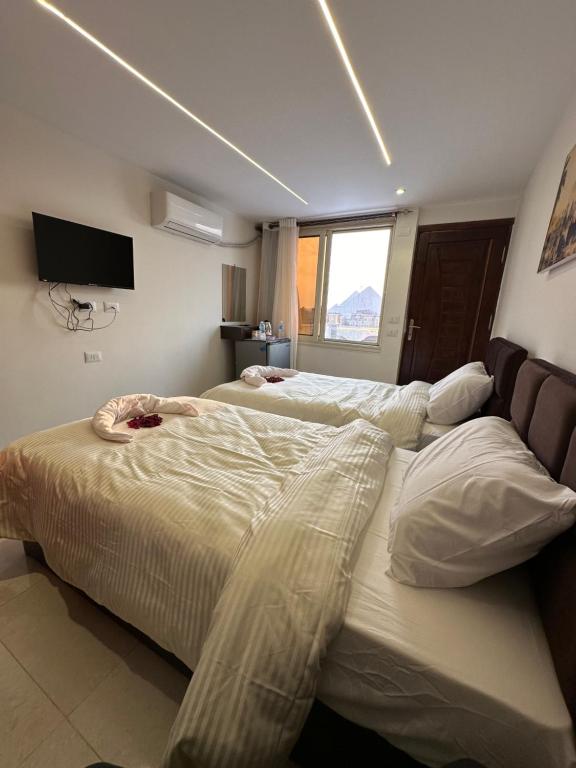 Postel nebo postele na pokoji v ubytování Sun 3 Pyramids Inn