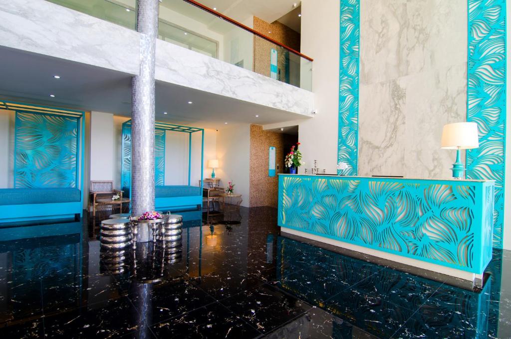 a lobby of a hotel with blue and white walls at Norn Talay Surin Beach Phuket in Surin Beach