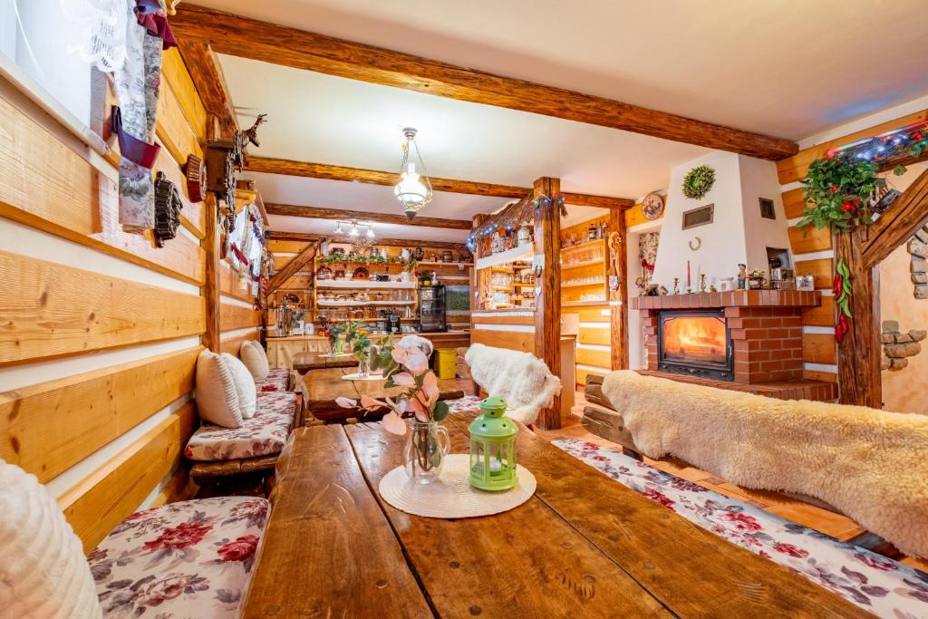 a living room with a wooden table and a fireplace at Apartmány Iwona in Rokytnice nad Jizerou