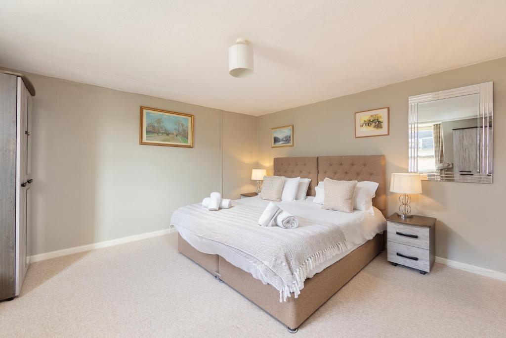 a bedroom with a large bed with white sheets and pillows at Lovely Georgian Loft in The Very Centre of Bath in Bath