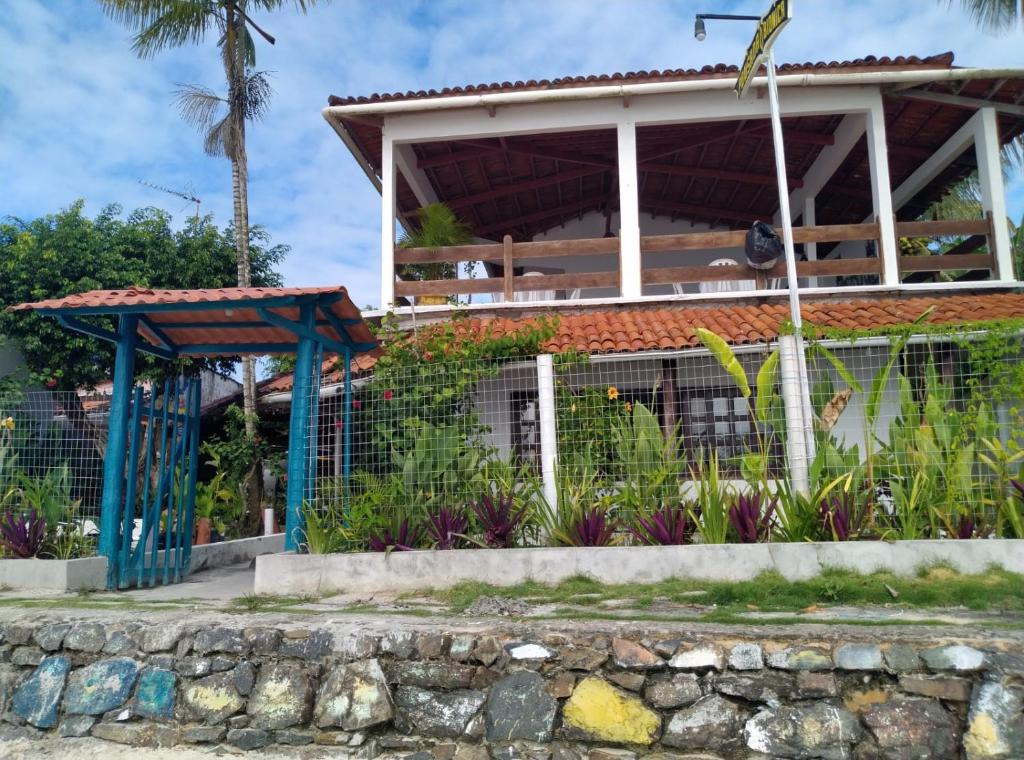 a house with a fence in front of it at Biônica Pousada in Cayru