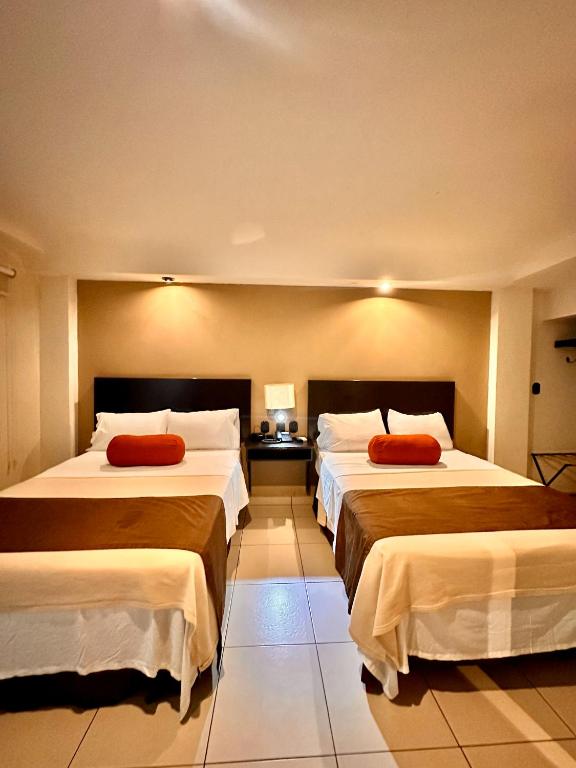 Postel nebo postele na pokoji v ubytování Hotel Centro Apatzingán