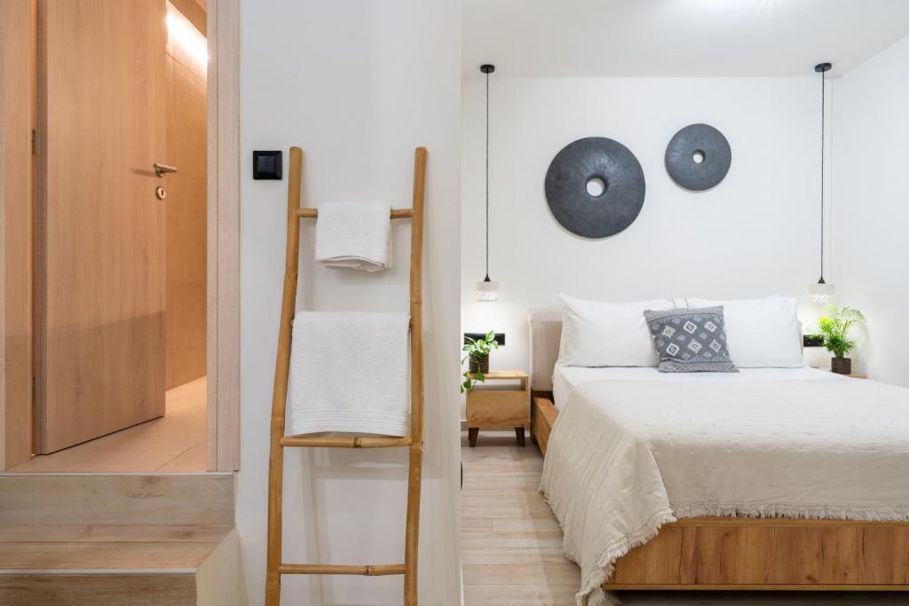 a bedroom with a bed and a mirror at Olea White in Skiathos Town