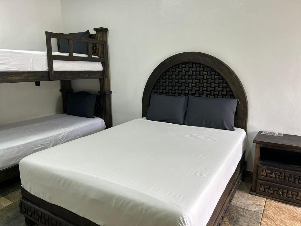 Postel nebo postele na pokoji v ubytování Hotel Villas Camargo