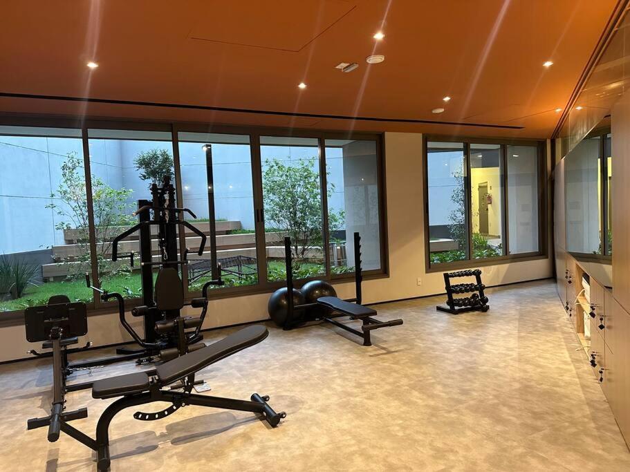 a gym with several exercise equipment in a room with windows at Apto premium próximo Allianz Parque e Espaço Unimed in Sao Paulo