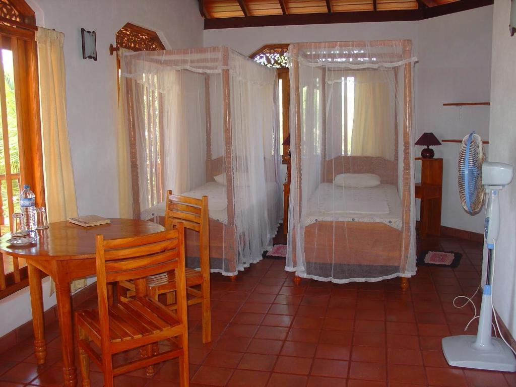 Postel nebo postele na pokoji v ubytování Patini Bungalows - Beach Garden