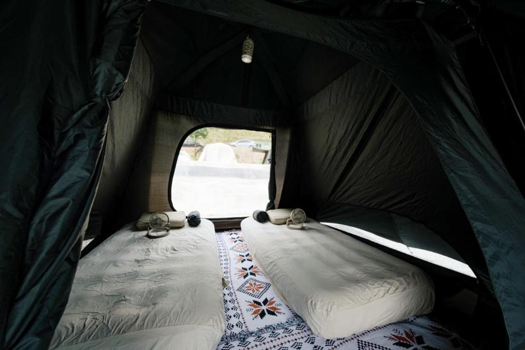 Postel nebo postele na pokoji v ubytování Camp Lù Yīng