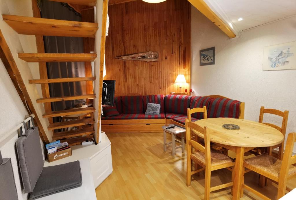 a living room with a table and a couch at MyHome - Génépis 29 - 4pax skis aux pieds Val Claret in Tignes