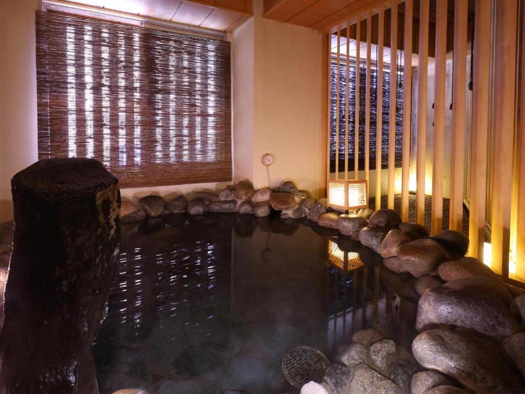 a pool of water in a room with at Dormy Inn Tsu in Tsu