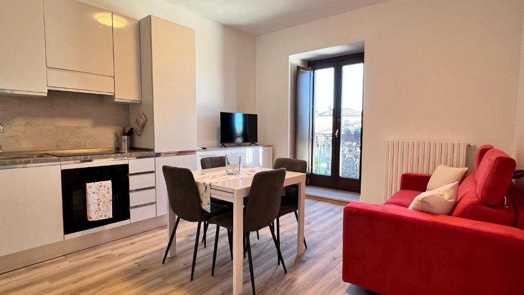a living room with a table and a red couch at Appartamenti Rocchesi in Rocca San Felice