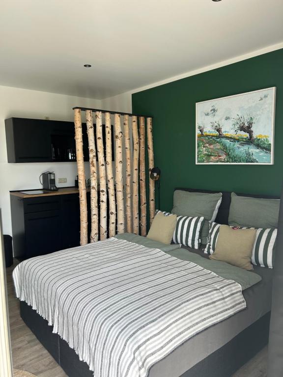 a bedroom with a bed with a striped blanket at Ferienwohnungen mit Feldblick in Schwerin