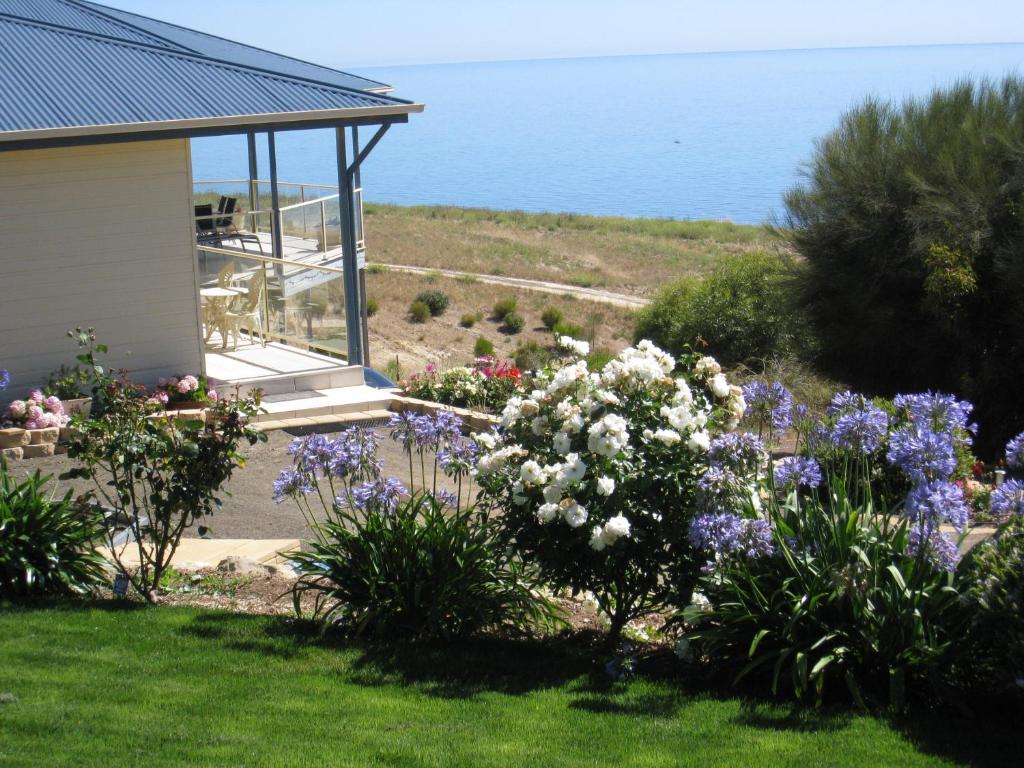 a garden with flowers in front of a house at Lindsays of Kangaroo Island in Penneshaw