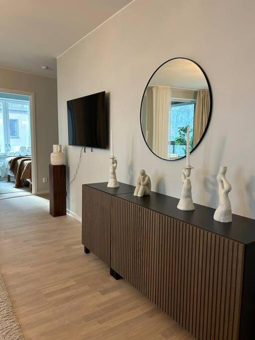 a living room with a mirror on the wall at Stylish Waterfront Apt Stockholm in Stockholm