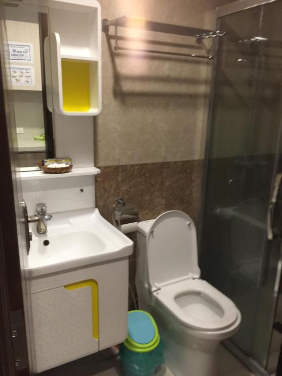 a bathroom with a toilet and a sink and a shower at Arkes Residential Condo Unit Rental in Baguio