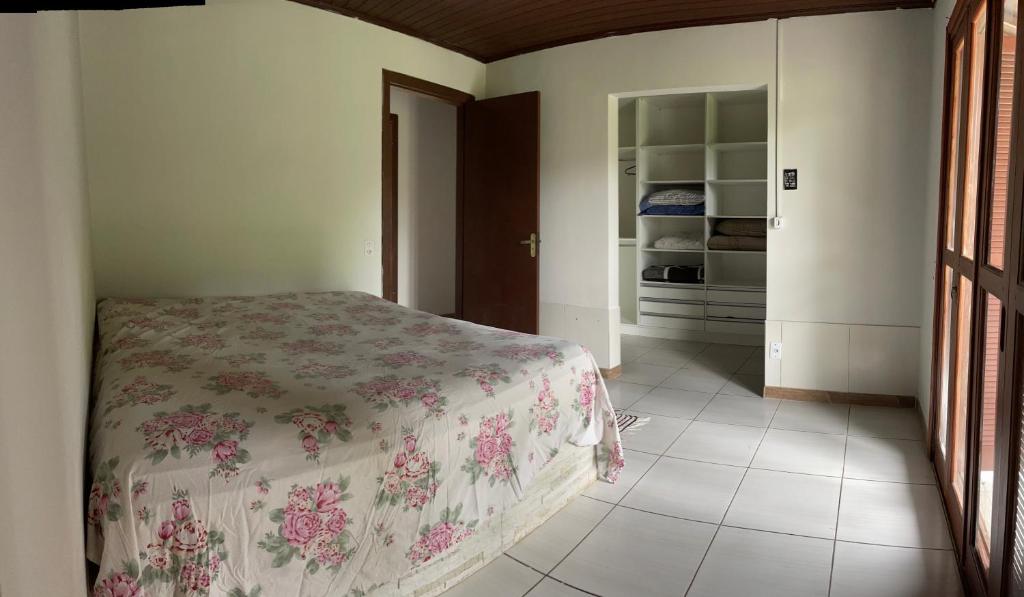 a bedroom with a bed and a walk in closet at Sítio recanto da Felicidade in Gravataí