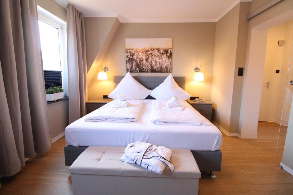 a hotel room with two beds with towels on them at La Bella Vita in Emden
