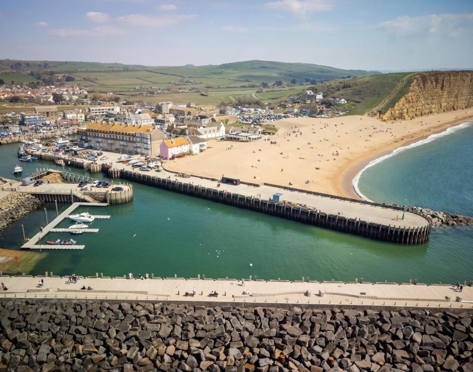 an aerial view of a beach with a pier and the ocean at Bridport Arms Hotel in West Bay