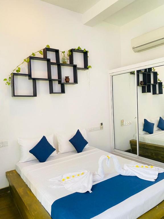 Postel nebo postele na pokoji v ubytování Sun Breeze Negombo