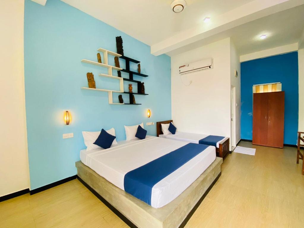 Postel nebo postele na pokoji v ubytování Sun Breeze Negombo