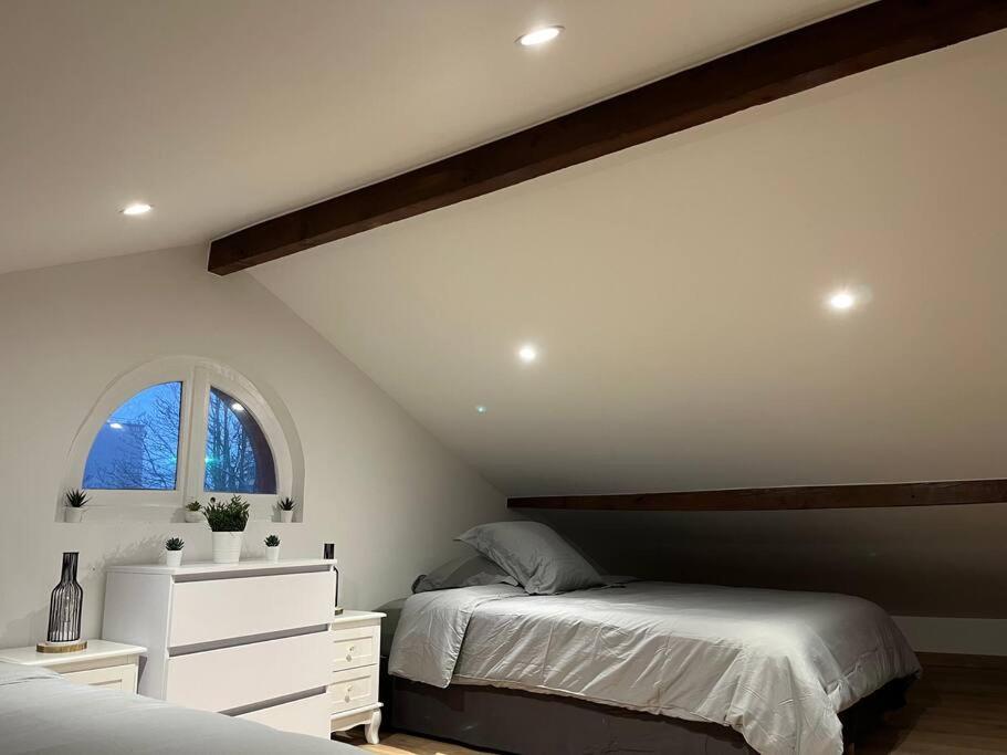 a bedroom with two beds and a window at BX - Maison 10 rooms - 12 beds - metro PARIS EXPO in Montrouge