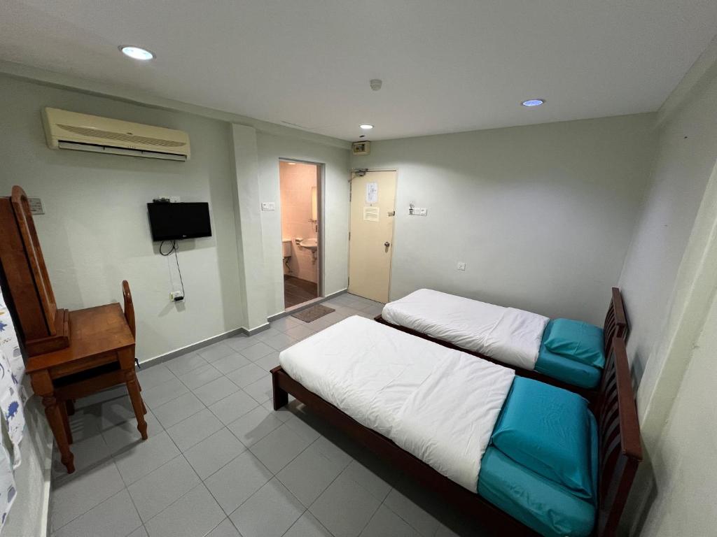 Postel nebo postele na pokoji v ubytování M Straits Hotel