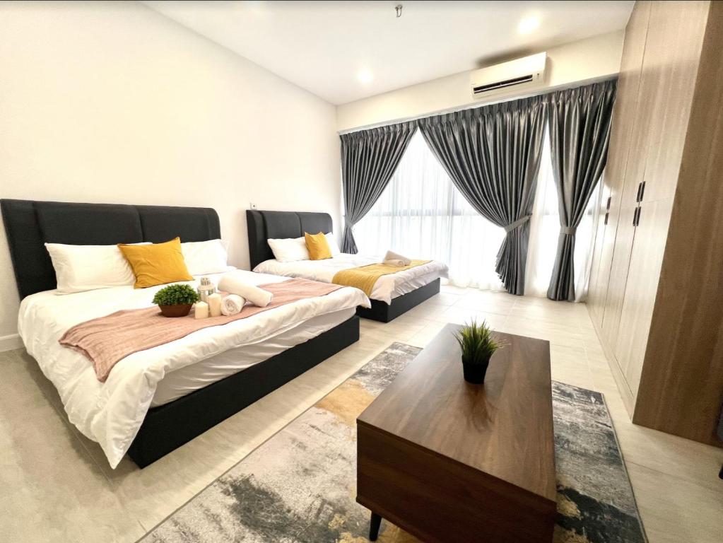 a living room with two beds and a couch at Free Parking Bell Suite Sepang Near KLIA Airport KL KLCC in Kampong Bekoh