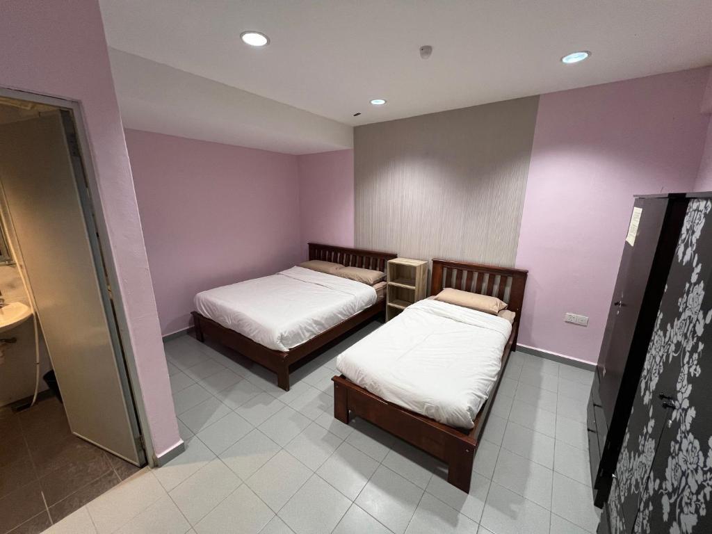 Postel nebo postele na pokoji v ubytování M Straits Hotel