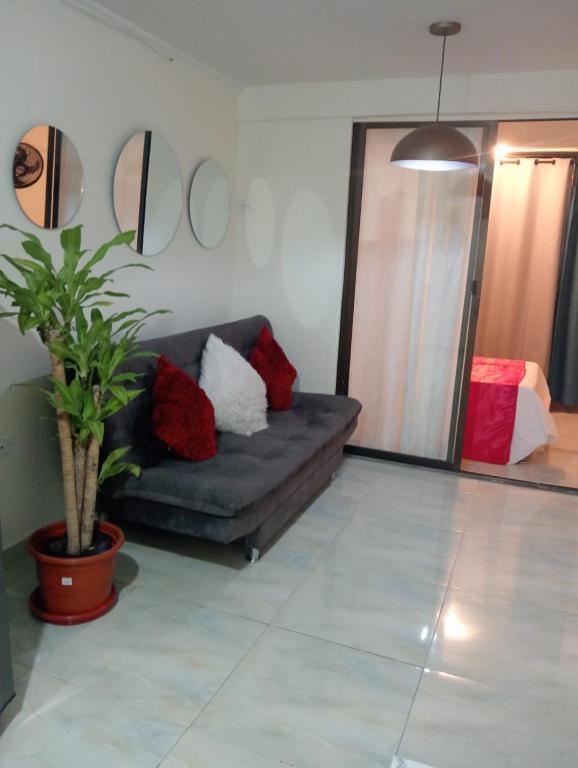 a living room with a couch and a potted plant at Apartamento cerca a Medellín - Puerta del norte Bello in Machado