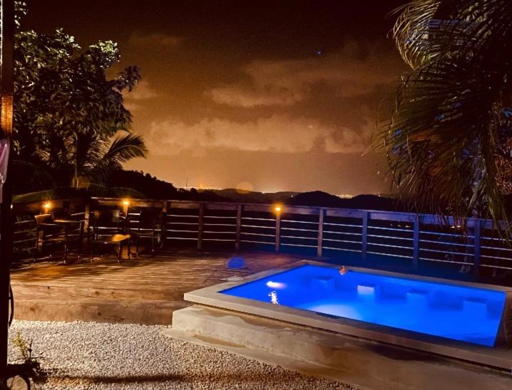 a swimming pool in a backyard at night at La Kolina Reserve in Ponce
