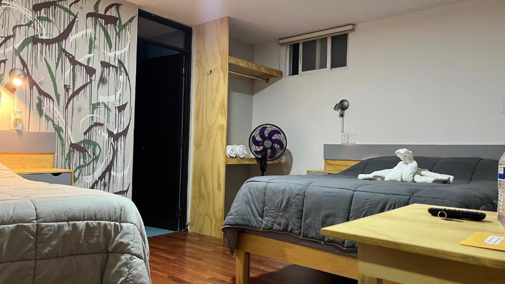Postel nebo postele na pokoji v ubytování El Suburbio - Serapio Rendon