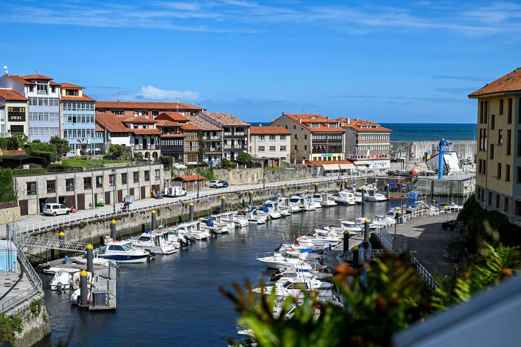 a group of boats are docked in a harbor at El Puerto Llanes, apartamento para 4 personas in Llanes