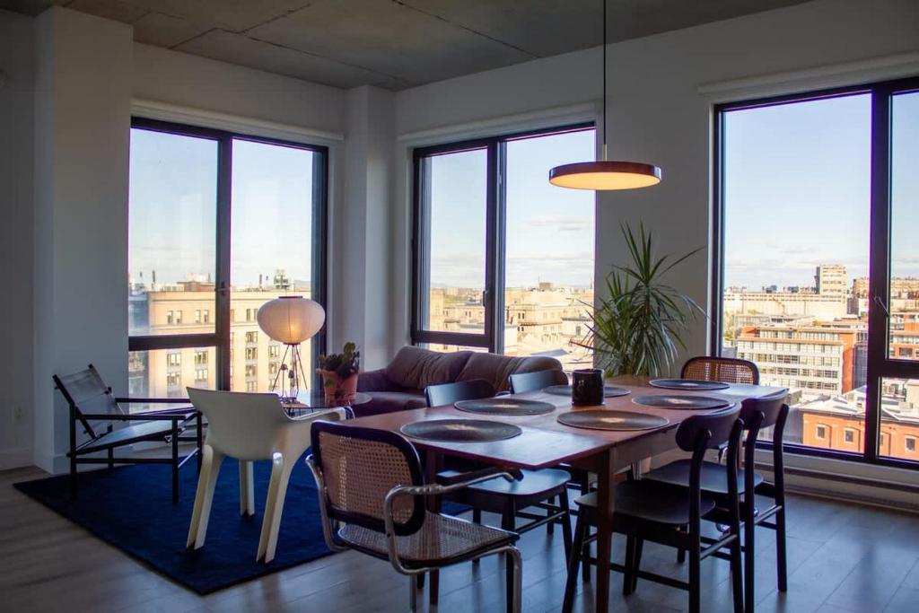 a living room with a table and chairs at Panoramic Apartment in the old port in Montréal