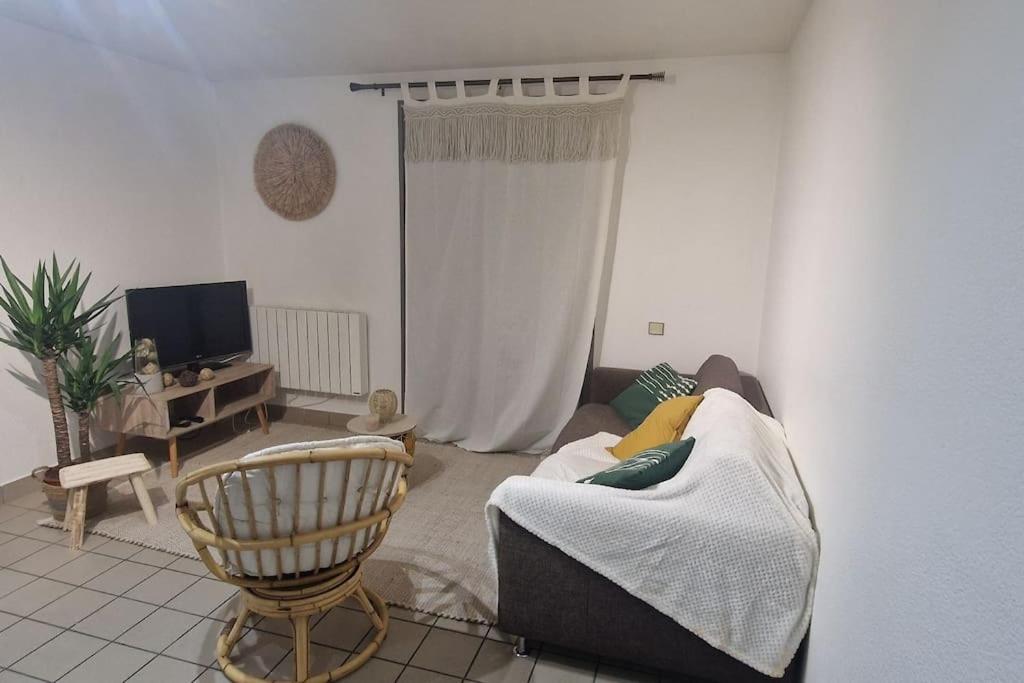 a living room with a couch and a chair at Au coeur de Vizille in Vizille